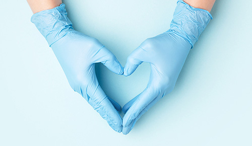 Gloved hands in the shape of a heart